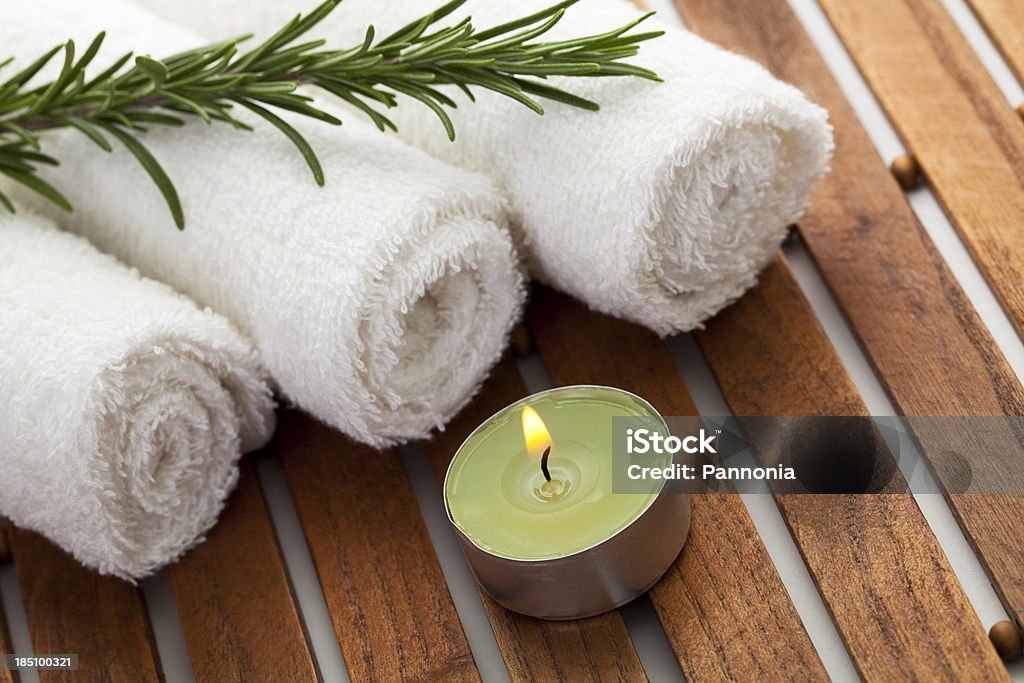 Spa concept with candle, towels, rosemary "Spa concept with candle, towels, rosemary" Aromatherapy Stock Photo