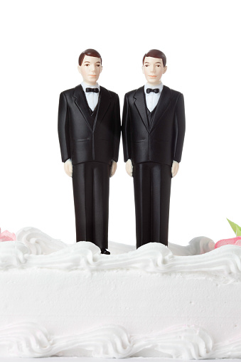 Two Groom Cake Topers on top of Wedding cake