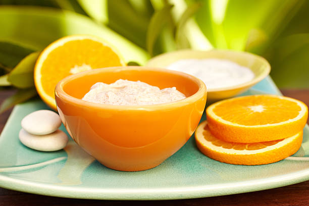istock Spa exfoliation salt scrub, oranges and moisturizer on a plate 185100469