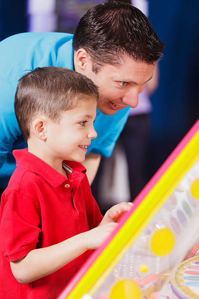istock Father and Son in an Amusement Arcade 185100809