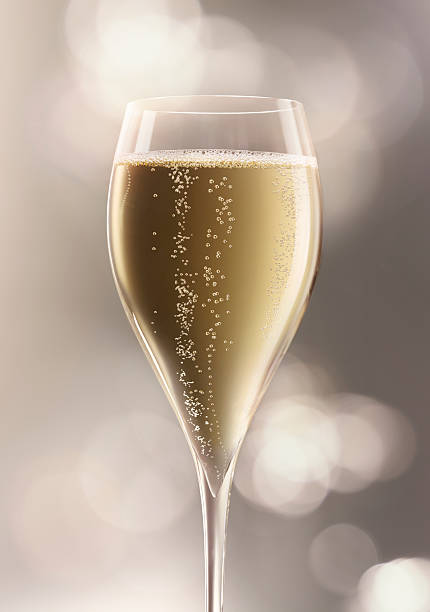 Champagne Glass of Champagne on background of defocused lights - Very High Resolution. More like this in my portfolio champagne bubbles stock pictures, royalty-free photos & images