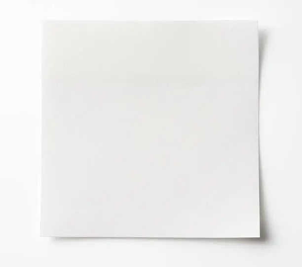 Photo of Isolated shot of blank white sticky note on white background.