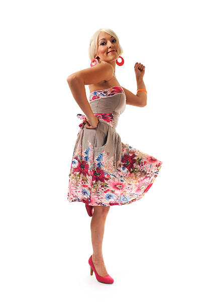 Dancing happy blonde in retro dress stock photo