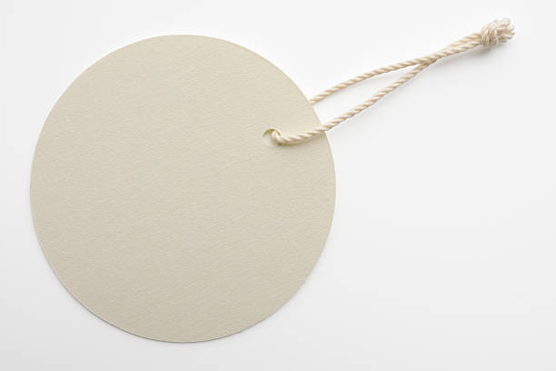 Isolated shot of blank white round tag on white background Blank white round tag isolated on white background with clipping path. price tag photos stock pictures, royalty-free photos & images