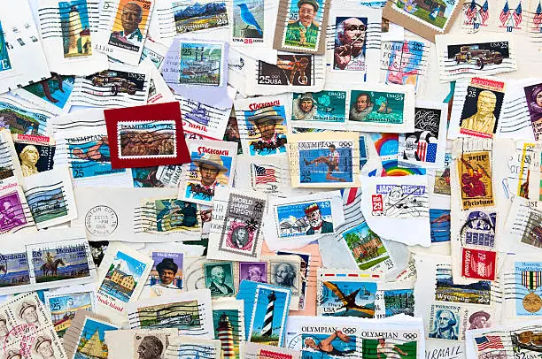 Collection of used U.S. stamps spanning several decades of U.S. postal history. Torn from envelopes.