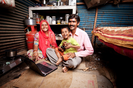 Cheerful Rajasthani Rural Indian Mother Father and Son with Laptop