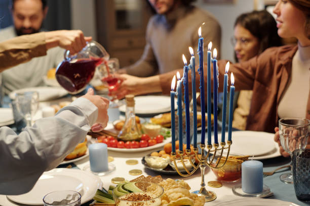istock Focus on blue burning candles on menorah candlestick standing on table 1851048715