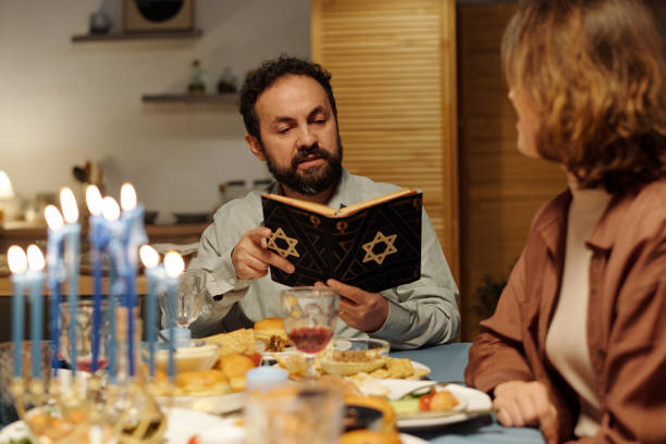 istock Serious mature Jewish man with open Torah reading Scripture texts 1851049317