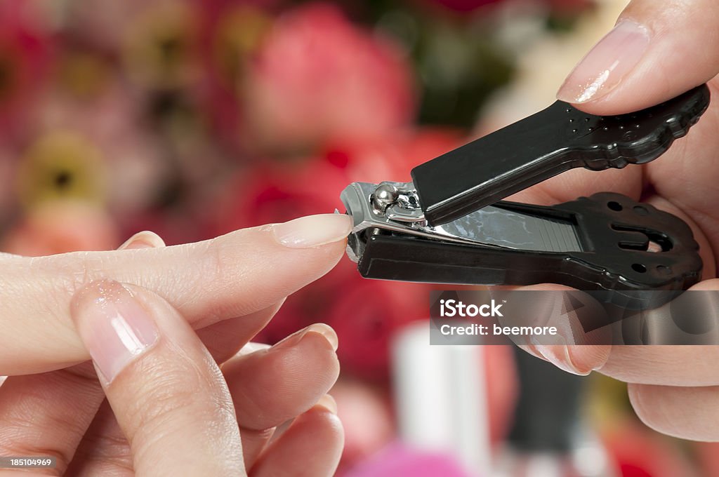 Manicure Female hands cutting off nails with a nail clipper. Beauty Stock Photo