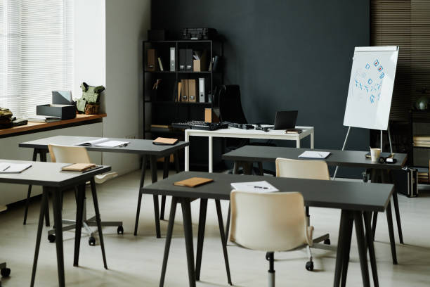 istock Part of spacious classroom with two rows of desks with chairs 1851056238