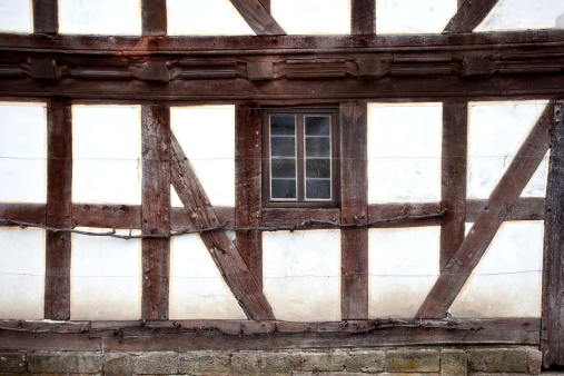 Quedlinburg, Saxony-Anhalt, Germany, 28 October 2022: Historic old vintage colored timber frame houses in medieval town, UNESCO World Heritage city, half-timbered home at sunny autumn day, cobblestone