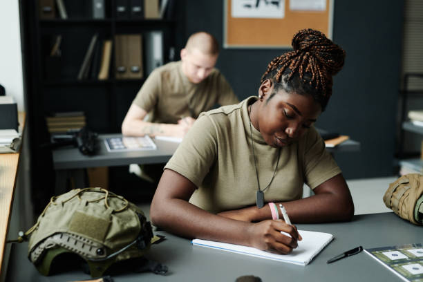Young African American female student making notes in notepad