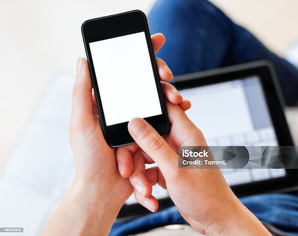 Woman Using Smartphone and Digital Tablet Close-up shot of a woman Using Smartphone and Digital Tablet simultaneously. Adult Stock Photo