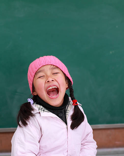 picture of one happy schoolgirl in front of blackboard