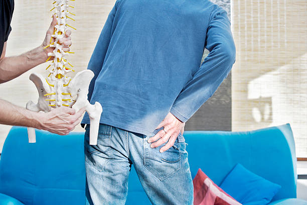 Hip pain "Typical pain in the hip joint, probably due to osteoarthritis. A finger is pointing at the affected region of an artificial model. XXL size image." pain points stock pictures, royalty-free photos & images