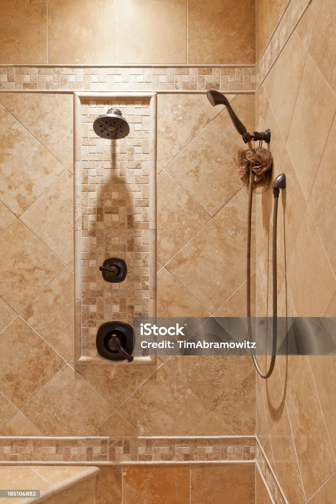 Luxury bathroom shower Custom luxury walk-in shower with tile and corner bench seat. Architectural Feature Stock Photo