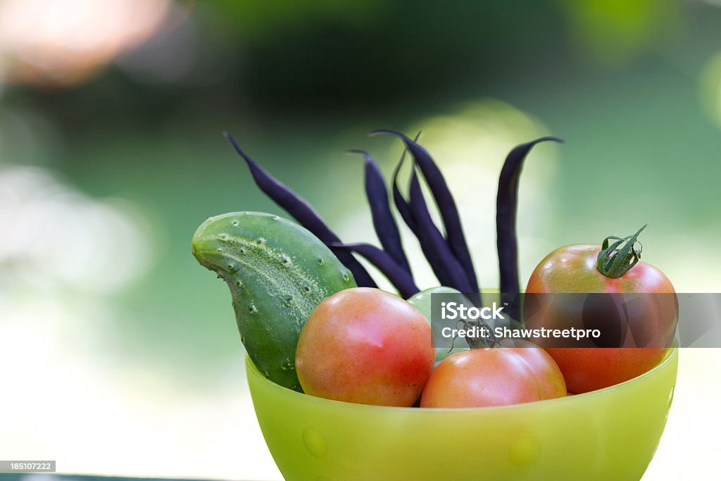 Assorted heirloom tomatoes and vegetables in a bowl Assorted heirloom tomatoes and vegetables in a bowl on a soft background in the summer Backgrounds Stock Photo