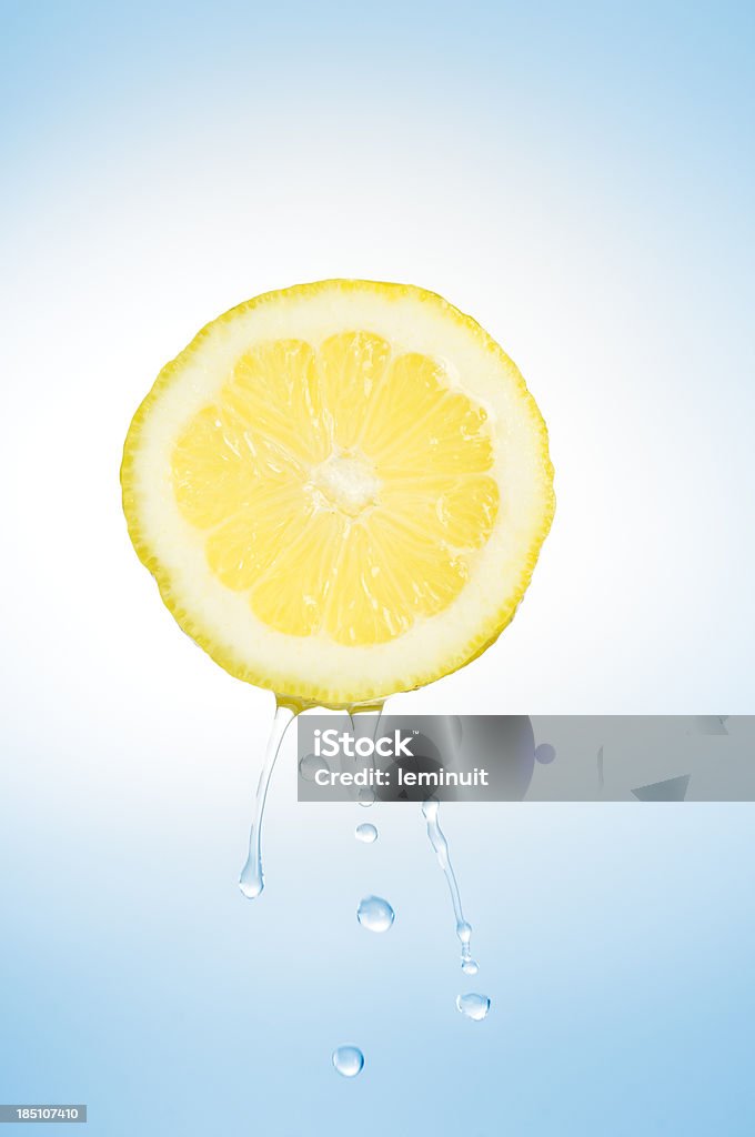 Fresh lemon A Lemon slice on air and some squeezed drops falling.If you need more fruits... Lemon - Fruit Stock Photo