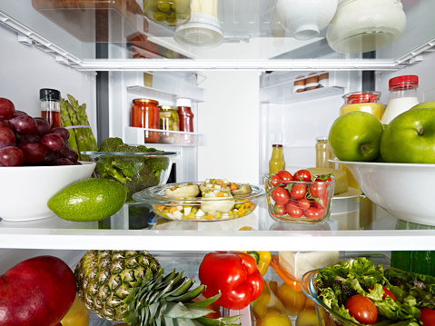 Fridge full of fruits, vegetables and diary products.