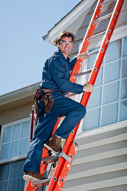 istock Handyman In Uniform Climbing Ladder 185107963