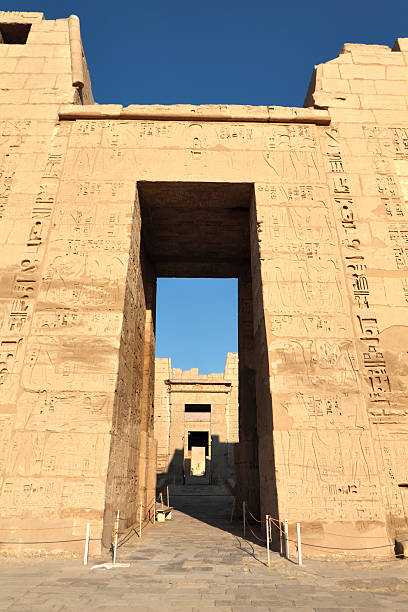 First Pylon, Medinet Habu, Theban Necropolis, Luxor, Egypt "The first pylon of Medinet Habu, the mortuary temple of the 12th century BC pharaoh Ramesses III (also Ramses, Rameses and Usermaatre-meryamun).  Located on the West Bank in the southern part of the Theban necropolis, Medinet Habu is one of the finest temples in Egypt." medinet habu stock pictures, royalty-free photos & images