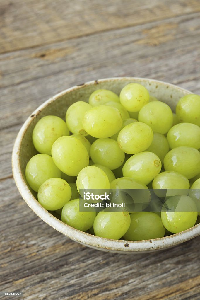 Small Bowl Of Organic Green Grapes On Rustic Wood Stock Photo