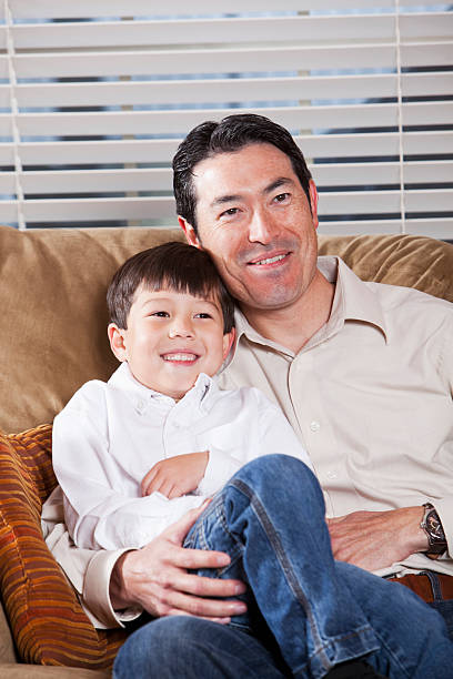 istock Father and son sitting on couch 185109402
