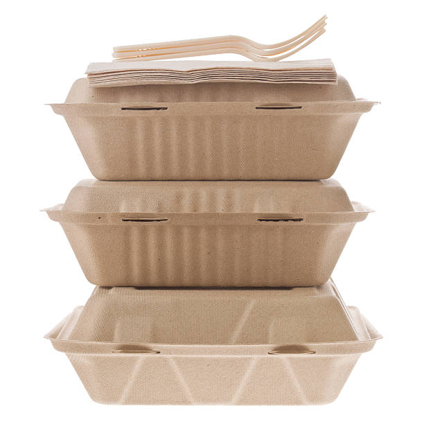 Containers To Go "A close up shot of three containers with food to go, some napkins and plastic forks, all three are made from recycled materials. Isolated on white." container stock pictures, royalty-free photos & images