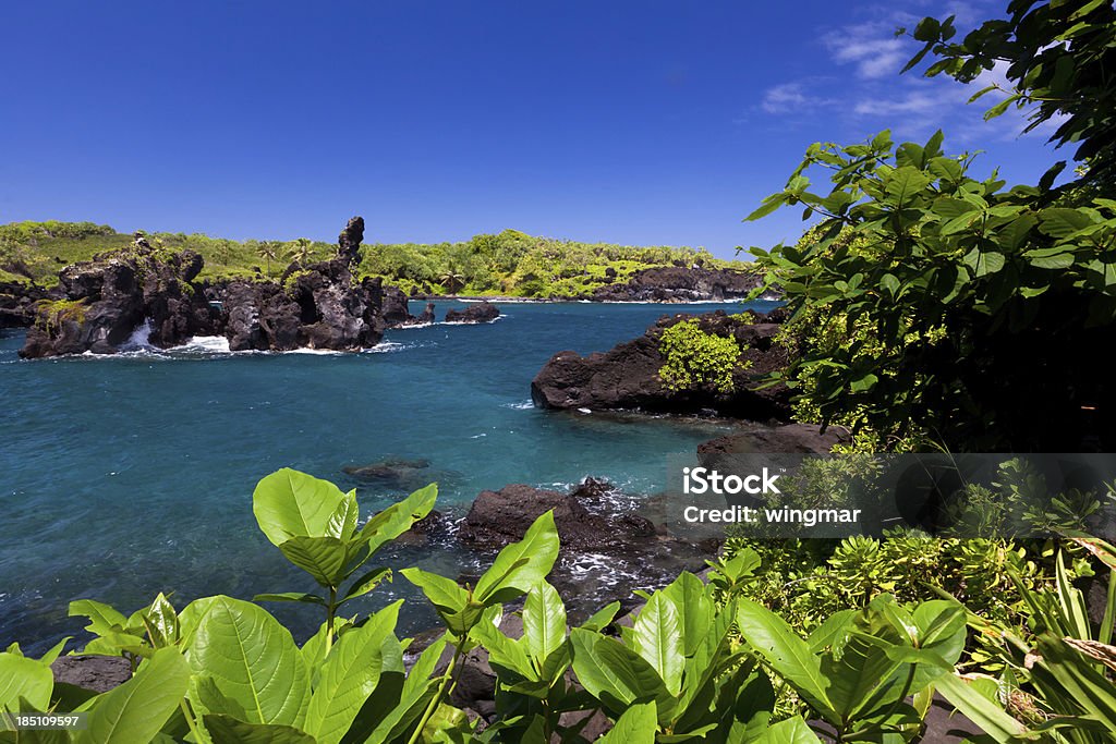 idyllic bay with blue ocean, maui, hawaii "idyllic bay with blue ocean, maui, hawaiiWaianapanapa State Park" Cliff Stock Photo