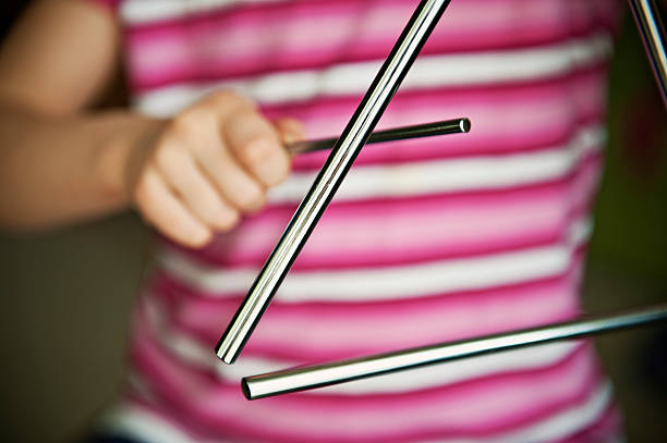 Child playing triangle  triangle percussion instrument stock pictures, royalty-free photos & images