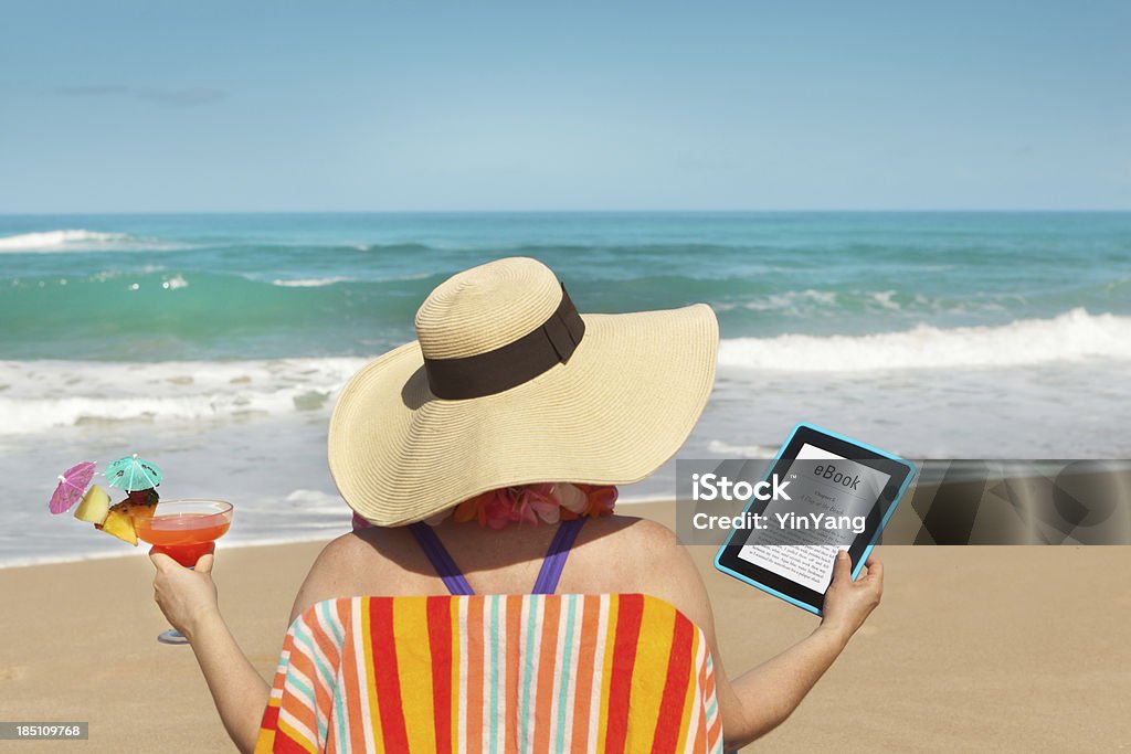 Summer Reading with eBook Tablet Computer on the Tropical Beach "Subject: A woman reading a eBook on vacation in tropical paradise beach.Location: Kauai, Hawaii, USA." Beach Stock Photo