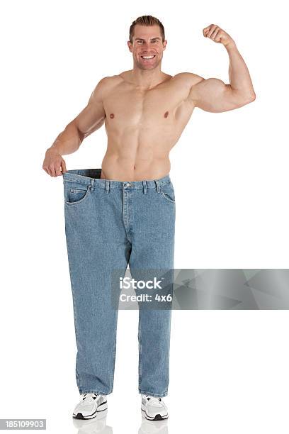Happy Man Showing Off His Weight Loss Stock Photo - Download Image Now - Men, Only Men, Too Big