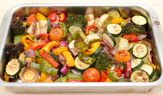 An assortment of roasted vegetables on a baking tray- studio shot