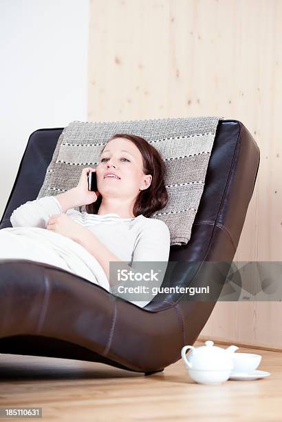 Junge Frau Mit Smartphone Auf Couch Stockfoto und mehr Bilder von Am Telefon - Am Telefon, Berühren, Berührungsbildschirm
