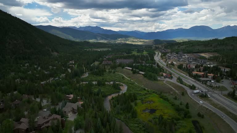 Downtown new Keystone ski resort city town aerial cinematic drone summer Breckenridge Colorado Vail resort Epic Pass ski snowboard bike golf course parking lot buildings forward slowly motion