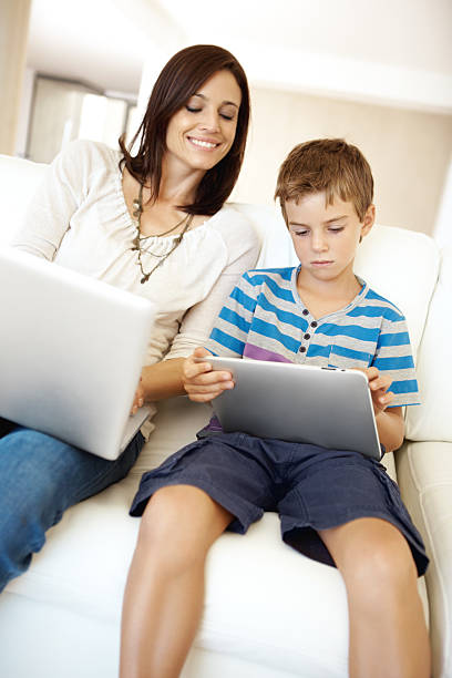 istock Admiring her son's quick grasp of new technology 185111701