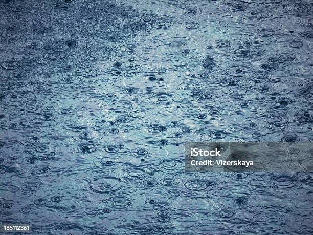 Raindrop Indentations On Water Stock Photo - Download Image Now - Abstract, Blue, Drop