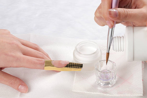 Manicure-acrylic nail Manicurist treating customer's nails at the beauty salon.Manicure treatment Dip Powder Nail Kits stock pictures, royalty-free photos & images