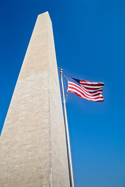 istock Washington Monument and Flag Under Clear Blue Sky 185112656