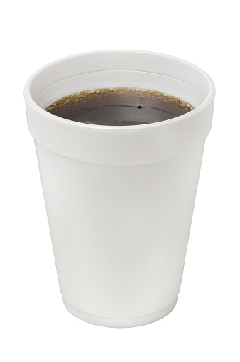 A styrofoam cup filled with dark soda.