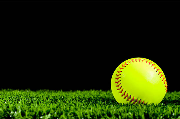 istock New Fast Pitch Softball in Grass for Night Game 185113196