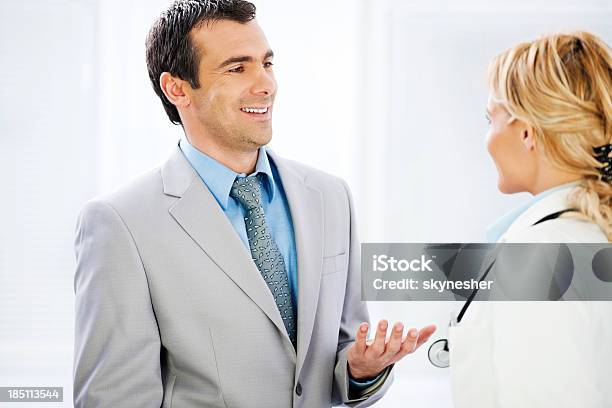 Business Men Talking To A Female Doctor Stock Photo - Download Image Now - Doctor, Patient, Business Meeting