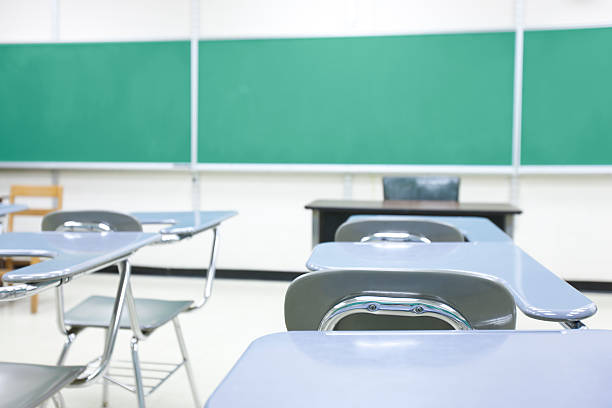 Classroom A view from a desk of the front of a modern school classroom. empty desk in classroom stock pictures, royalty-free photos & images