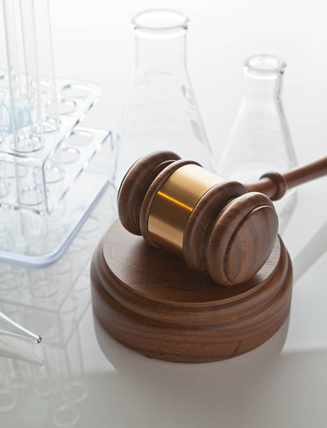 Gavel & Laboratory Equipment Laboratory Equipment on reflective surface with gavel, CLICK TO SEE MORE! food and drug administration stock pictures, royalty-free photos & images