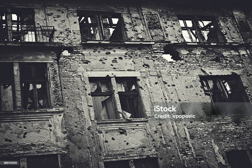 Ruin of War Residental building facade heavily damaged in the Balkans war. Toned image. War Stock Photo