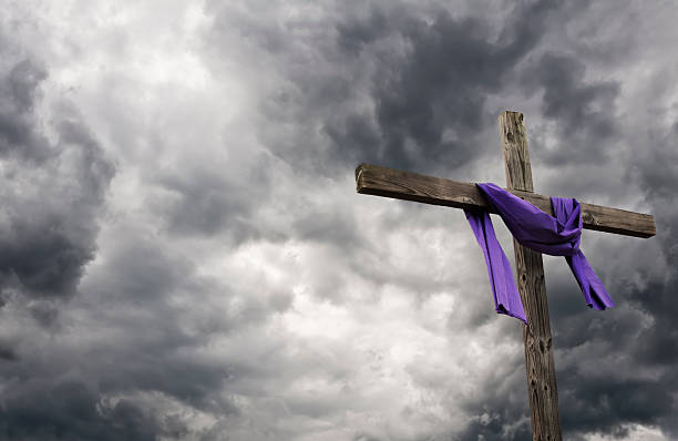 Easter Cross Cross with purple cloth draped over. crucifix photos stock pictures, royalty-free photos & images