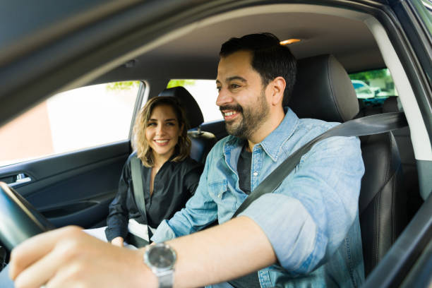 istock Cheerful happy couple laughing while driving the car 1851156141