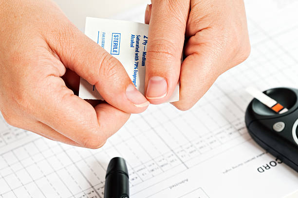 istock Daily diabetic routine: swab, glucometer and insulin pen on chart 185116021