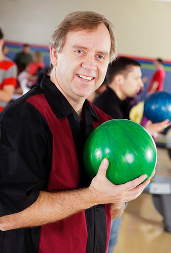 A man having fun while bowling.