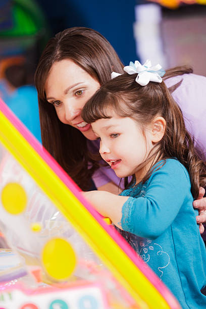 istock Mother and Daughter in an Amusement Arcade 185116324